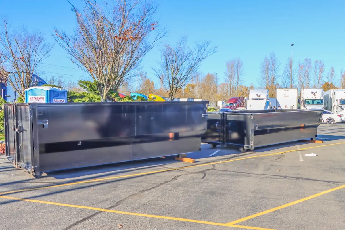 Professional dumpster rental service with roll-off container on residential driveway in Oakdale